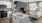 Model kitchen at our apartments in St Cloud, featuring granite countertops and a view of the living room. 