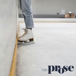 a ice skater standing in a ice rink