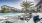 The pool area at our apartments in St Cloud, featuring reclining chairs, palm trees, and a view of the apartments. 